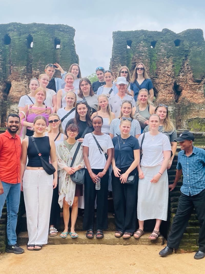 A tour group gathered on the steps of the Polonnaruwa ruins