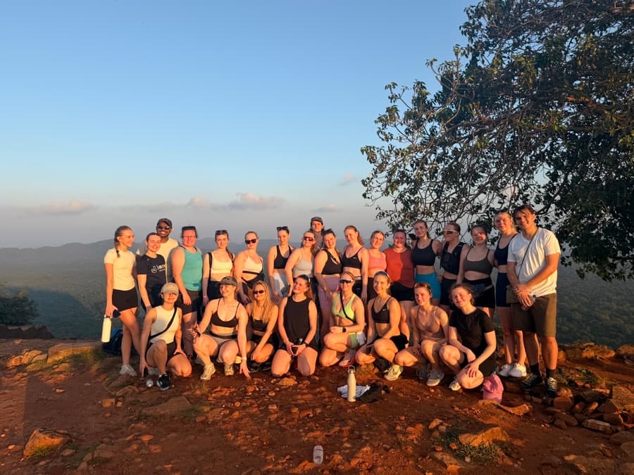 A group at a hilltop viewpoint after a sunrise hike