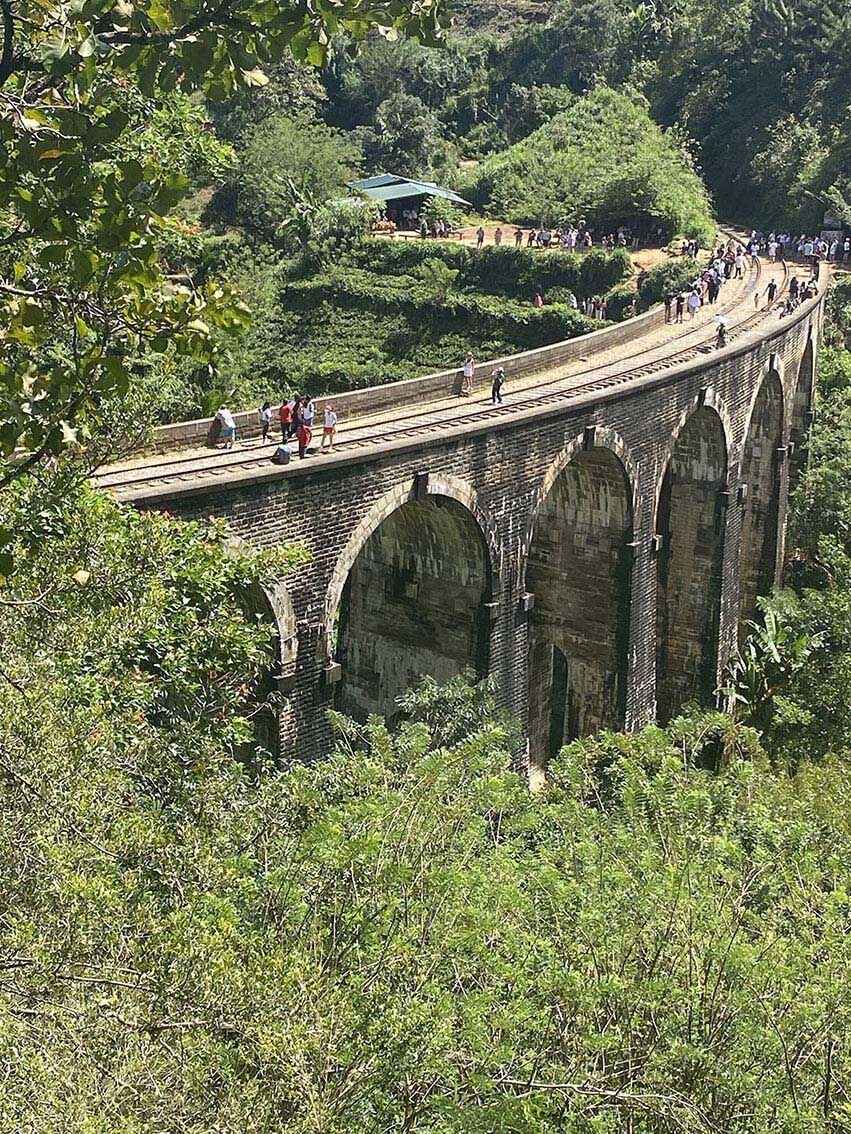 Walkers crossing the Nine Arch Bridge at Ella