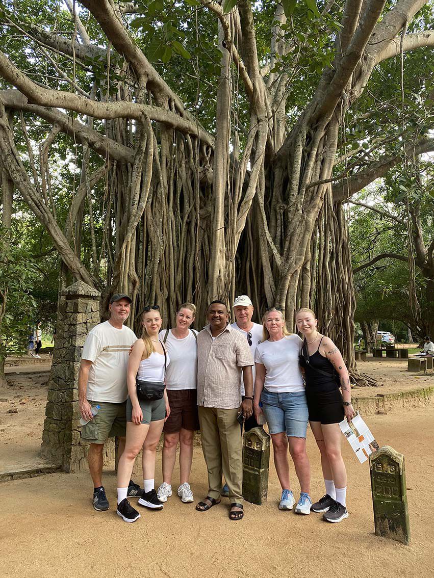 The group under a banyan tree with their guide