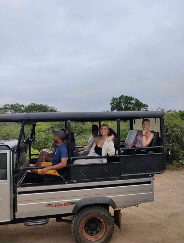 Waving from the back of a safari truck