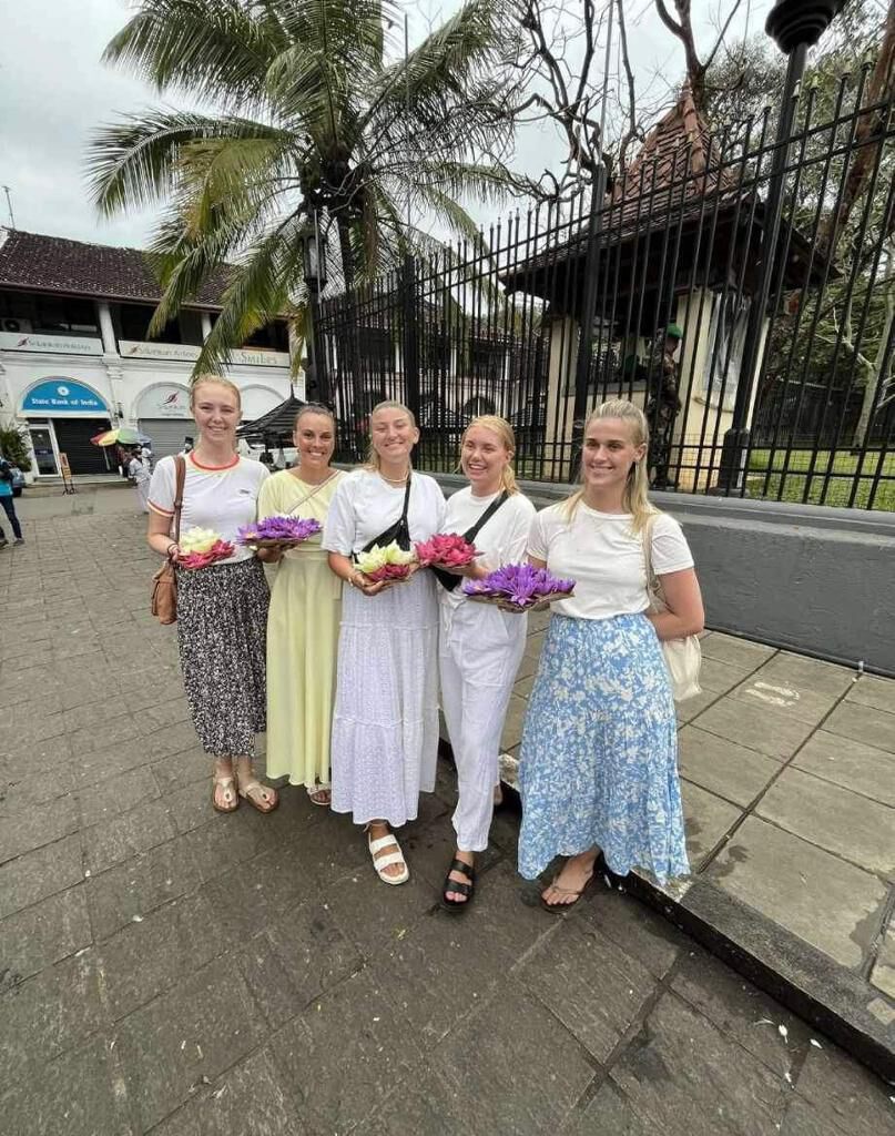 The group in white, carrying lotus offerings to a temple