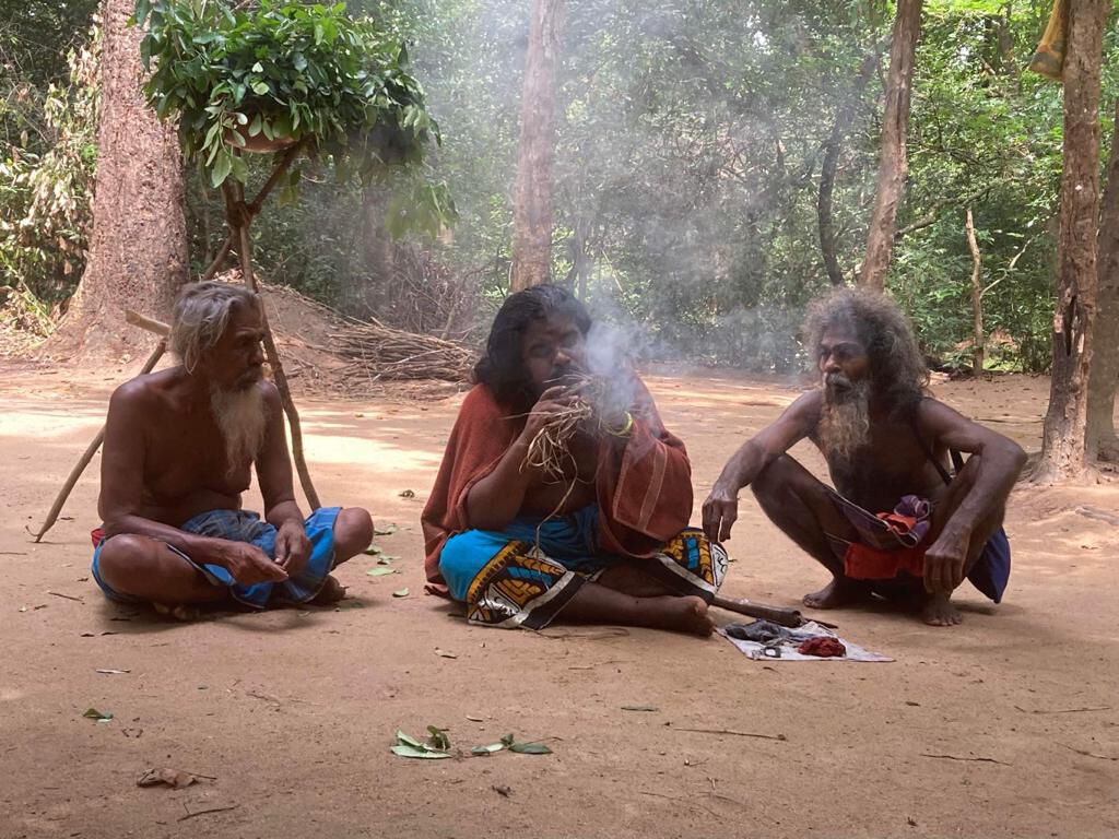 Vedda elders around a fire in the forest