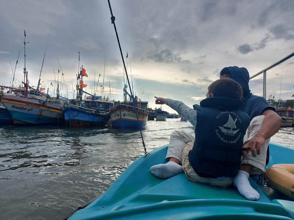 Watching the fishing fleet from the bow of a boat