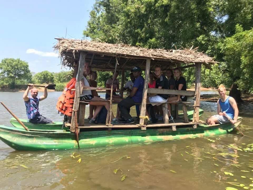 A group under the awning of a river boat