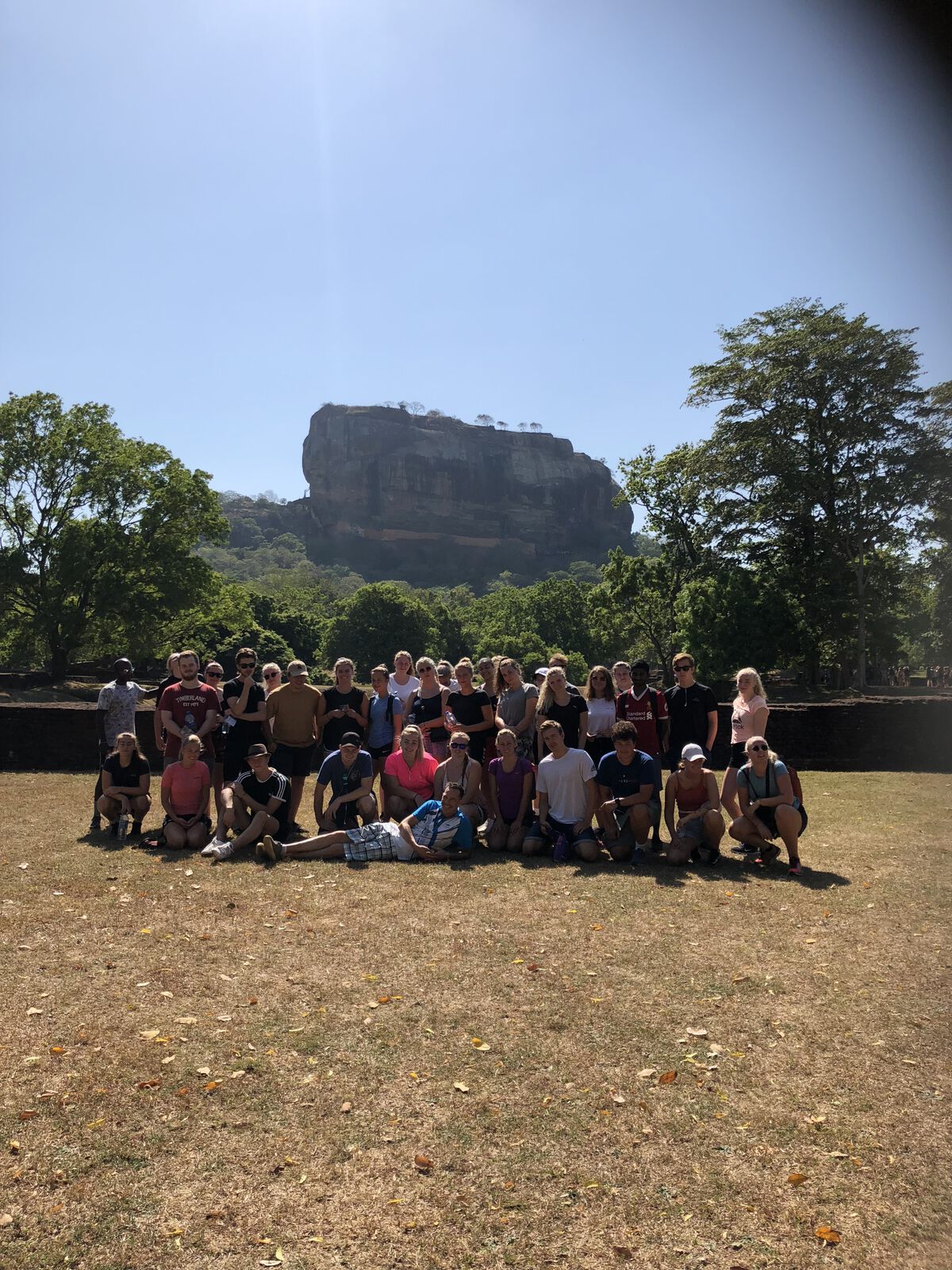 A tour group photographed below Sigiriya rock