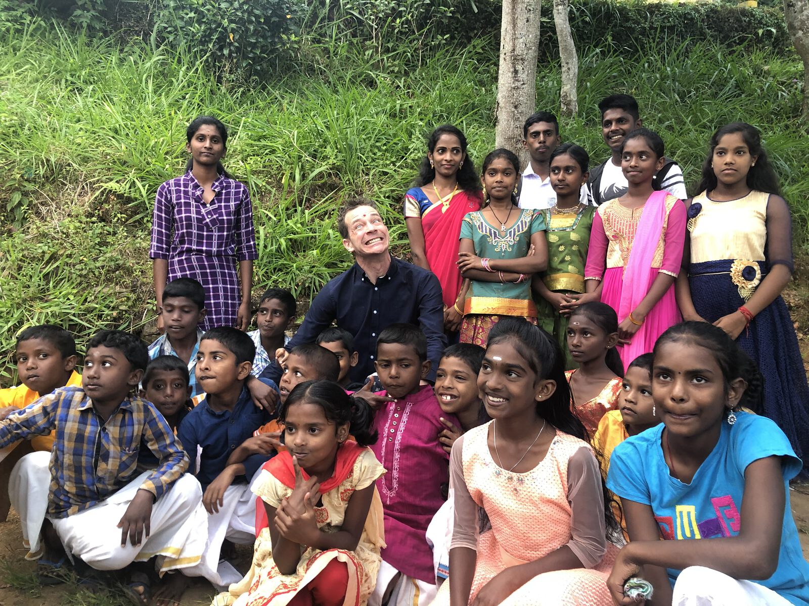 Sitting with schoolchildren and their families